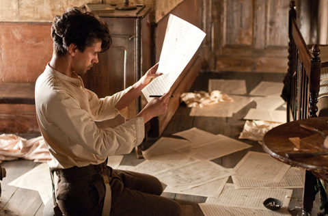 A composer reading music in official Cloud Atlas promotional imagery
